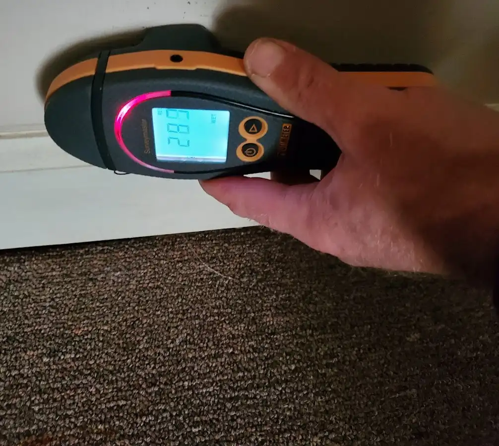 Moisture detection at baseboard during Storm Damage Restoration in London